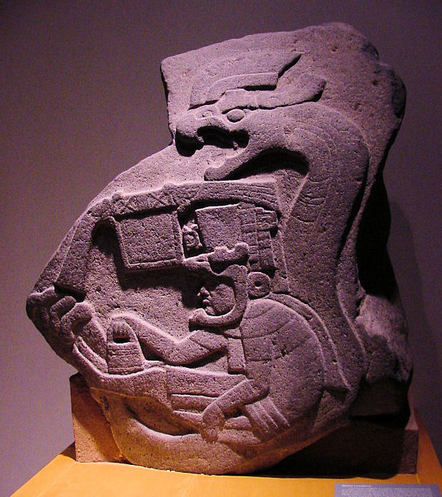 La Venta Monument 19: a seated human figure enclosed by the body of a large birdlike serpent.