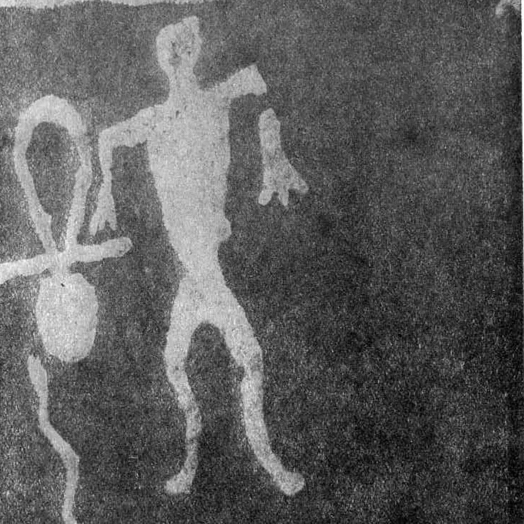 Cropped 1938 photograph of the Old Zalavruga petroglyph showing a looped cross-like sign beside a human and serpent